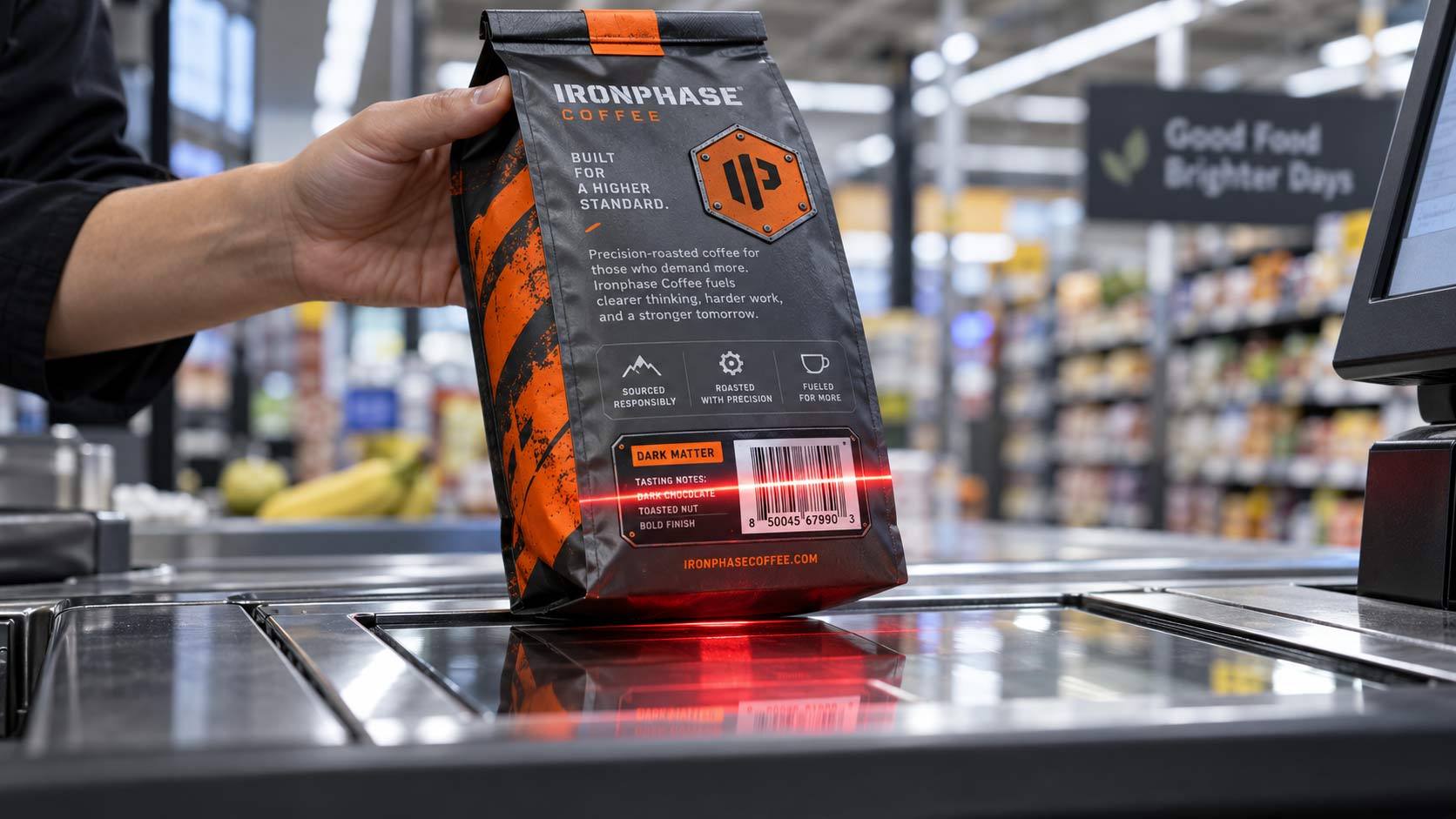 A coffee bag passing over a flat glass checkout scanner with the red scanner line crossing its back panel