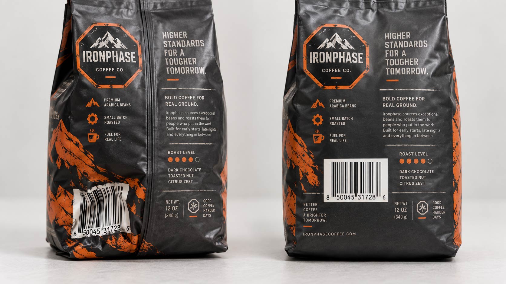 Two identical filled coffee bags side by side, one with the barcode buckling across the back seam in the bottom corner and one placed correctly on the flat of the panel