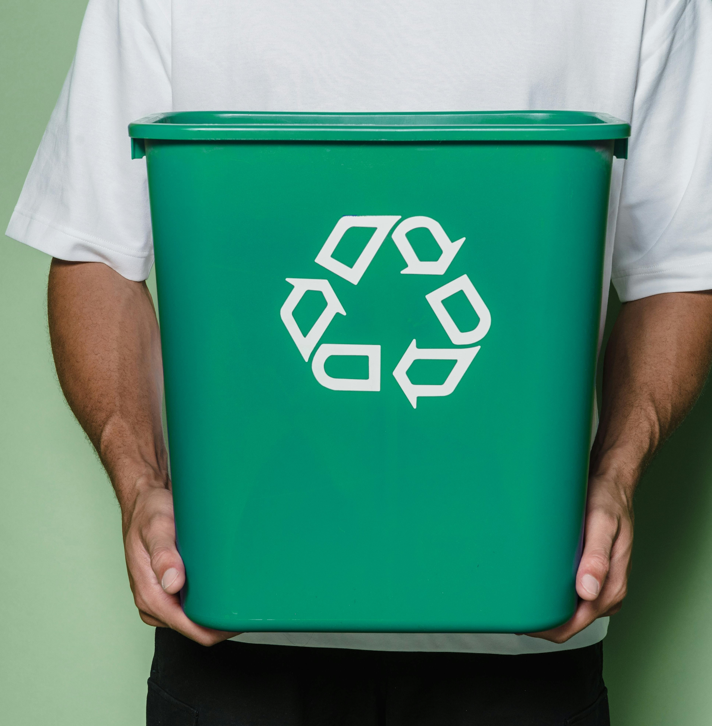 Man holding green bin for green waste.