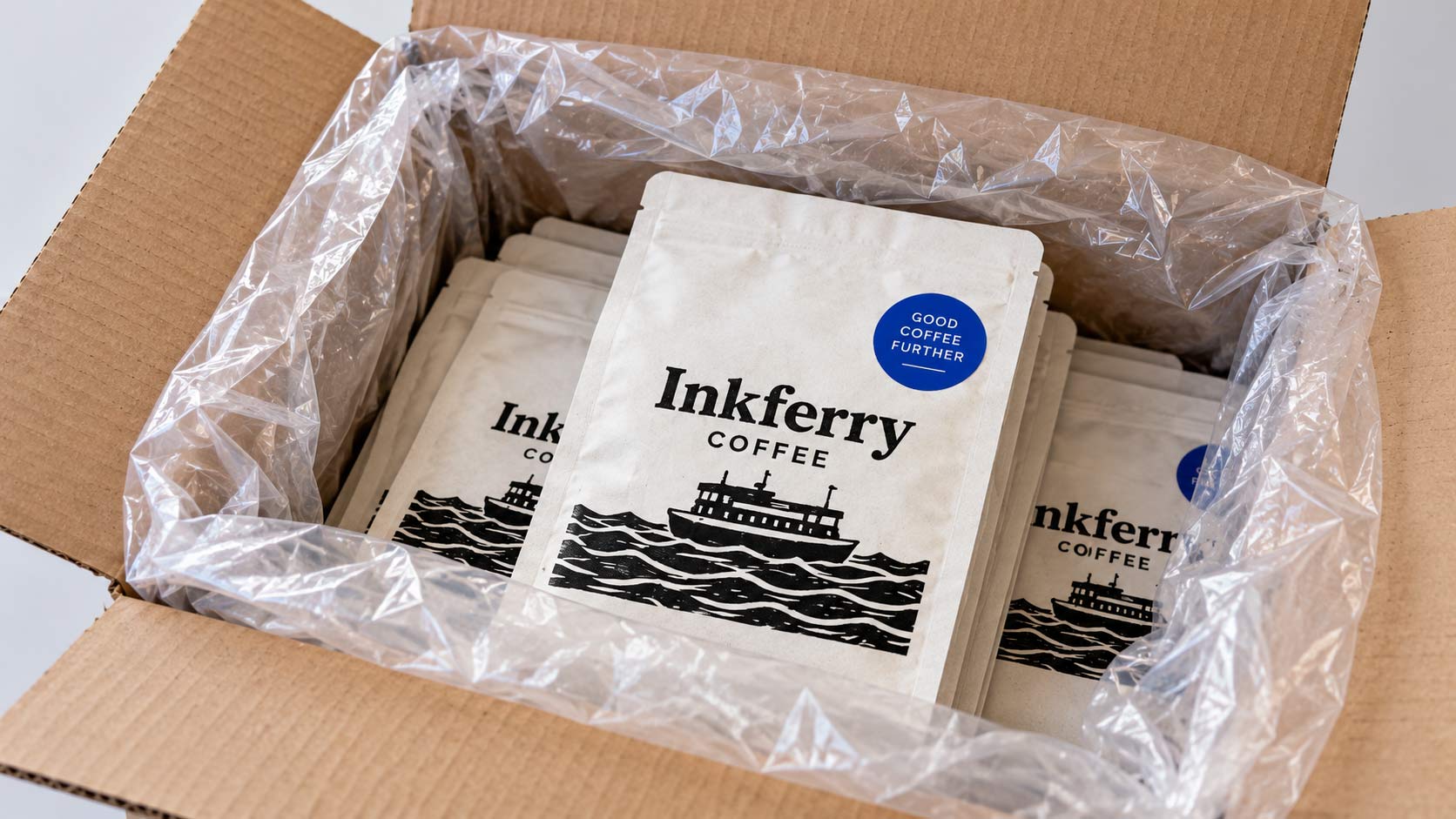 A carton of new coffee bags with the sealed poly liner folded open on a workbench