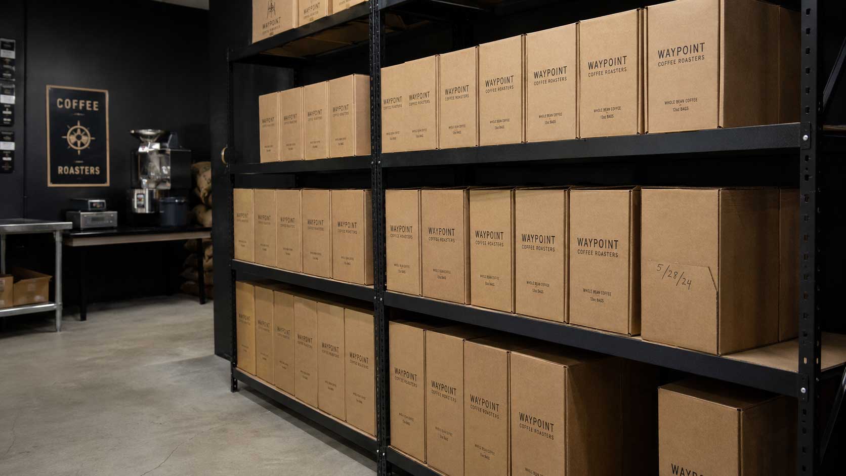 Sealed cartons of unfilled coffee bags stored upright on interior shelving in a cool, dim roastery stockroom